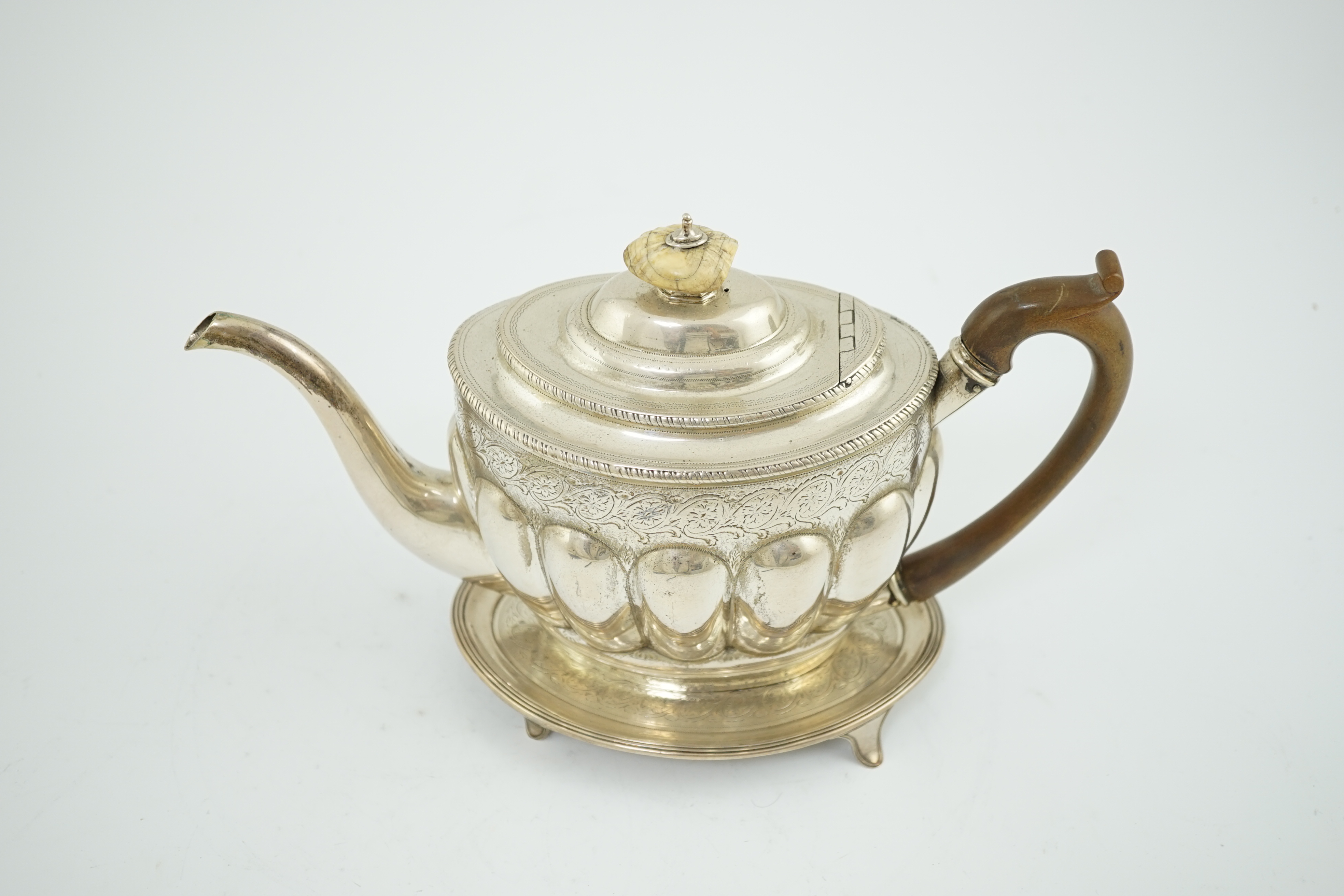 A George III engraved silver oval teapot by Soloman Hougham, together with a George III silver oval teapot stand, by John Eames, 16.8cm, CITES Submission reference YNZWLYTV